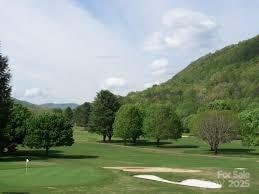 view of community featuring a mountain view and a lawn