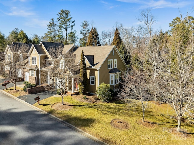 view of front of property featuring a garage and a front lawn