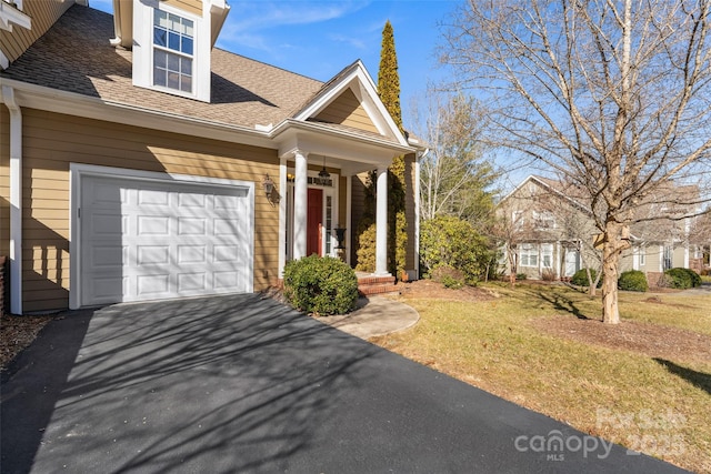 view of front of home with a garage and a front yard