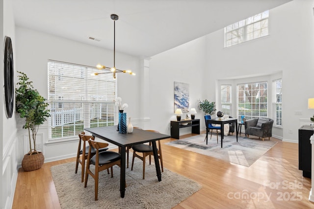 dining area with hardwood / wood-style floors and a chandelier