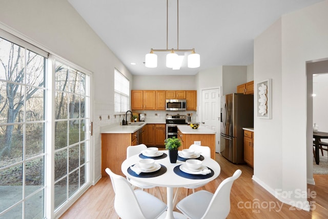 dining room with sink and light hardwood / wood-style floors