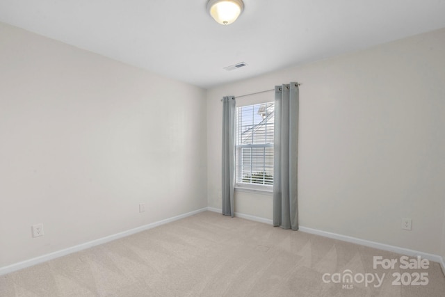 empty room featuring light colored carpet