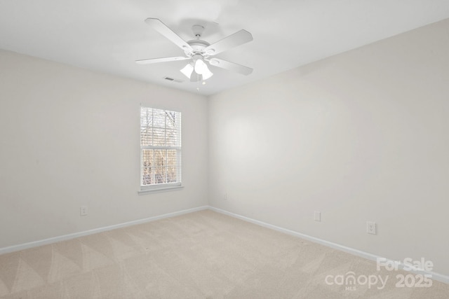 carpeted spare room featuring ceiling fan