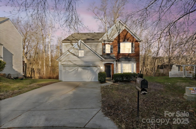 front facade with a garage and a lawn