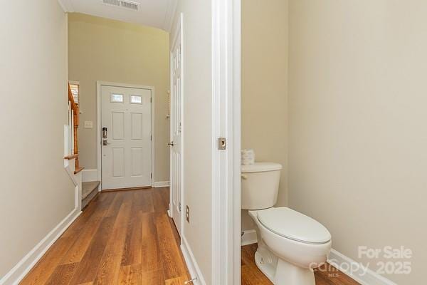 bathroom with hardwood / wood-style floors and toilet