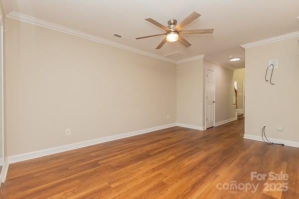 unfurnished room with hardwood / wood-style floors, ornamental molding, and ceiling fan