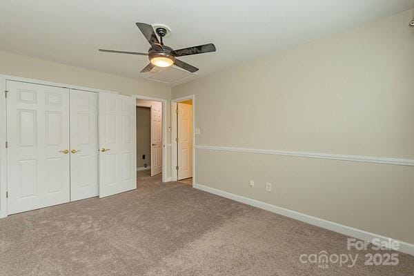 unfurnished bedroom with ceiling fan, carpet flooring, and a closet