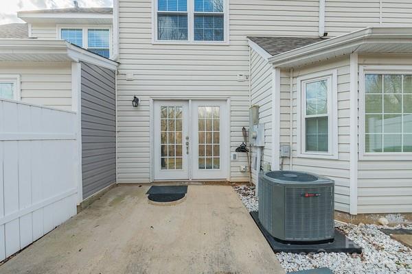 entrance to property with a patio, central AC unit, and french doors