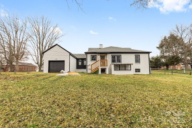 view of front of home with a garage and a front lawn