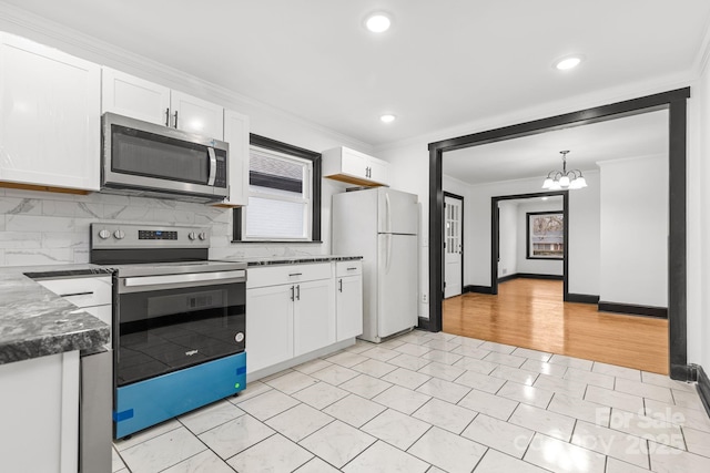 kitchen featuring white cabinetry, appliances with stainless steel finishes, backsplash, and pendant lighting