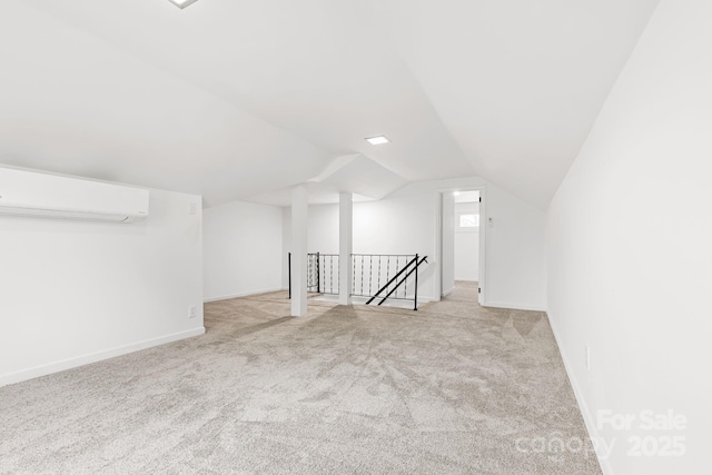 bonus room with light colored carpet, vaulted ceiling, and a wall unit AC