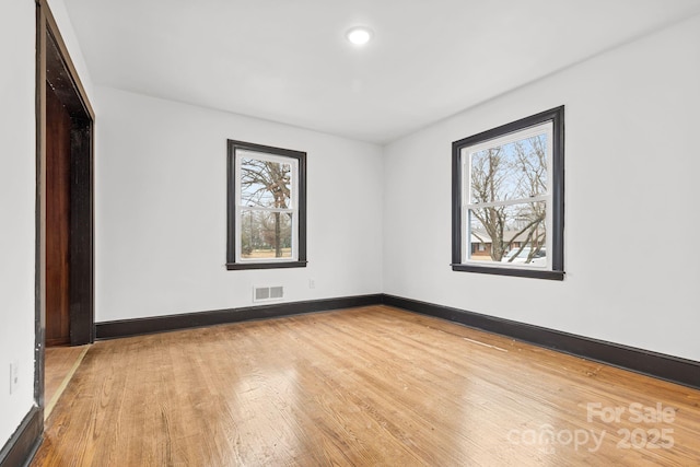 spare room with light hardwood / wood-style floors