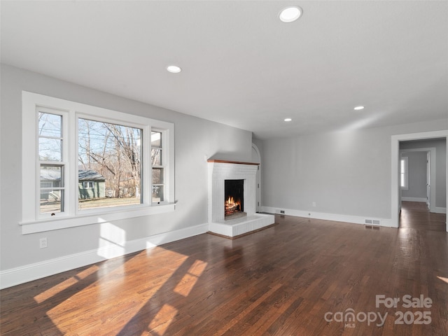 unfurnished living room featuring dark hardwood / wood-style flooring