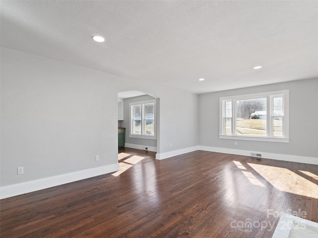 unfurnished living room with dark hardwood / wood-style flooring