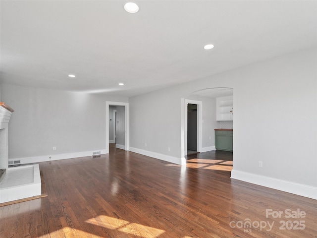 unfurnished living room with dark hardwood / wood-style flooring