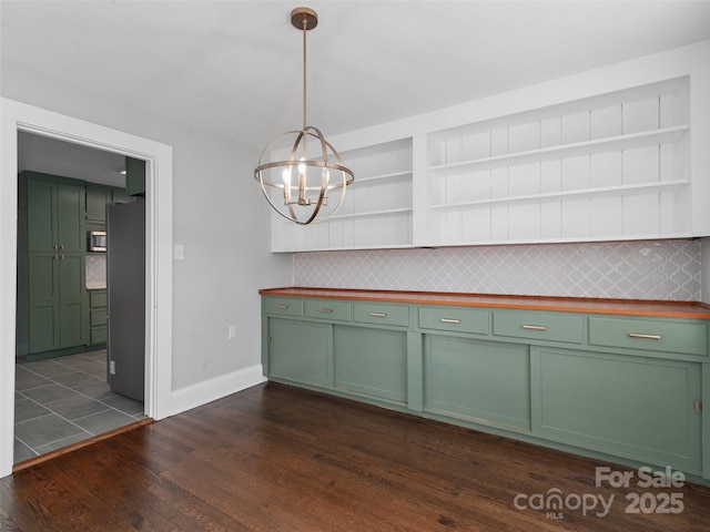 unfurnished dining area featuring dark hardwood / wood-style floors and an inviting chandelier