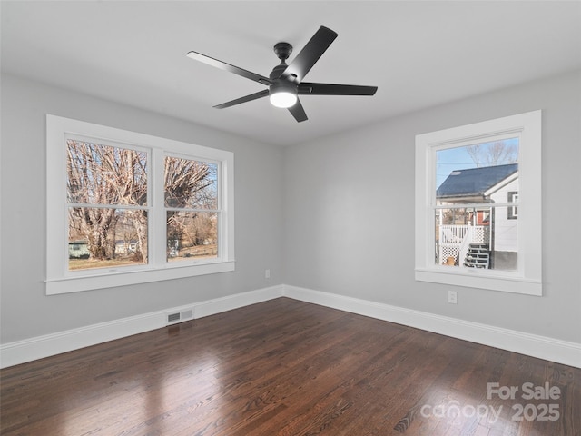 spare room with ceiling fan and dark hardwood / wood-style floors