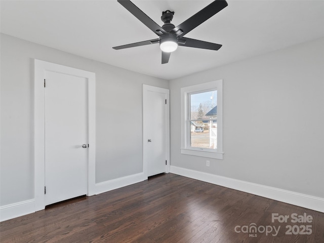 unfurnished bedroom featuring ceiling fan and dark hardwood / wood-style flooring