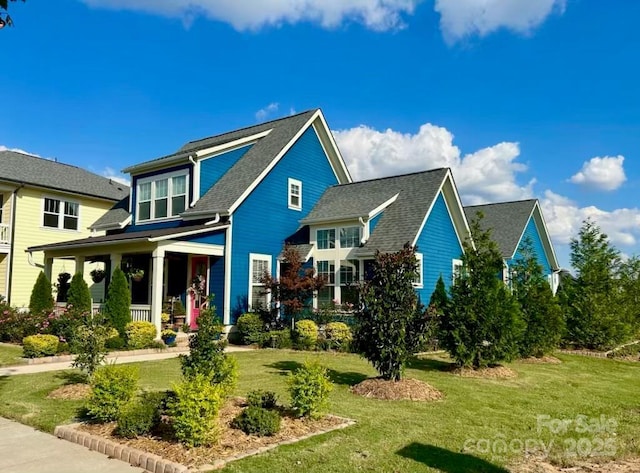 back of property featuring a porch and a lawn