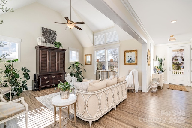 living room featuring crown molding, ceiling fan, high vaulted ceiling, and hardwood / wood-style floors