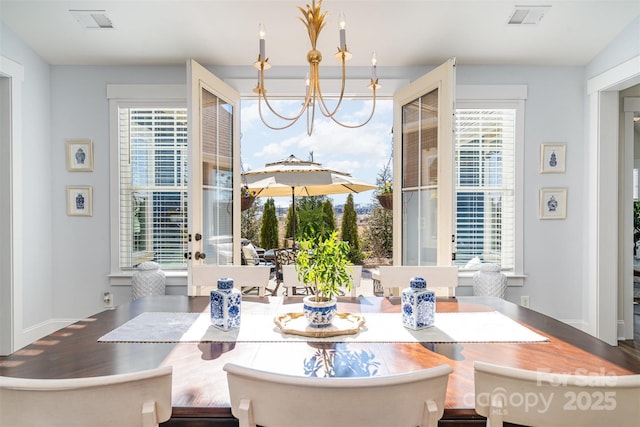 dining space with an inviting chandelier