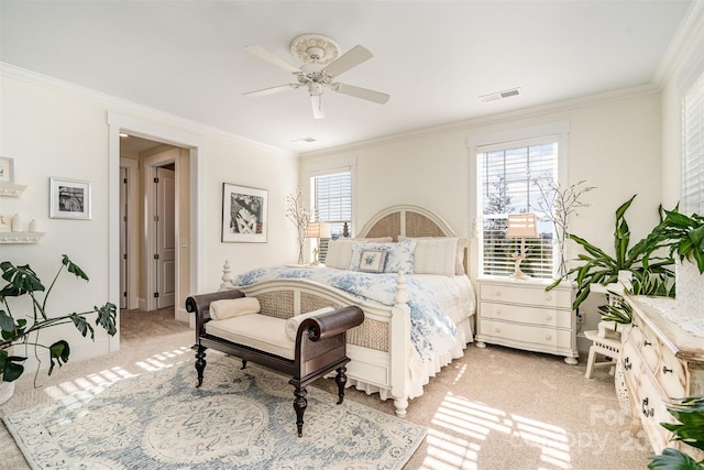 bedroom with multiple windows, crown molding, and light carpet