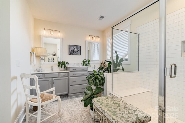 bathroom with an enclosed shower and vanity