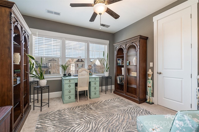 carpeted office featuring ceiling fan