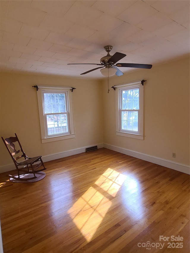 empty room with ceiling fan and light wood-type flooring