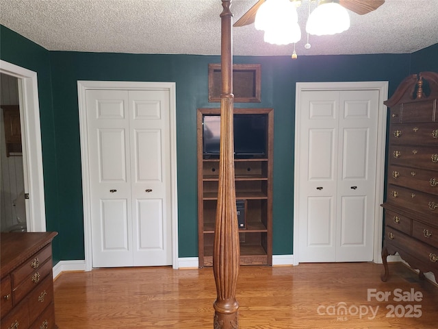 bedroom with light hardwood / wood-style floors and a textured ceiling