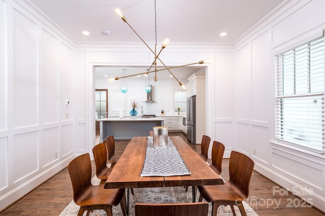 dining room featuring crown molding and dark hardwood / wood-style floors