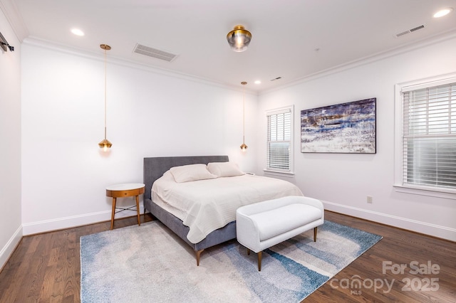 bedroom with ornamental molding and dark hardwood / wood-style floors