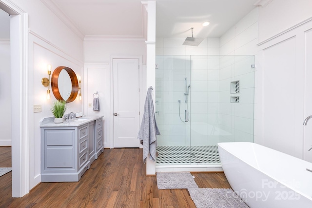 bathroom with hardwood / wood-style flooring, ornamental molding, vanity, and separate shower and tub