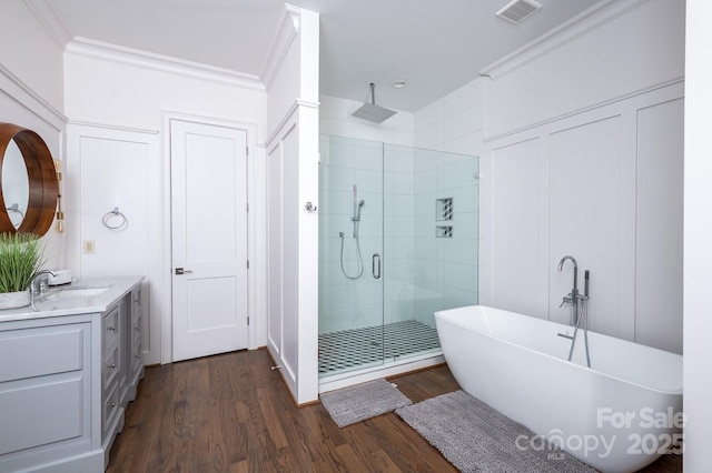 bathroom featuring independent shower and bath, crown molding, hardwood / wood-style floors, and vanity