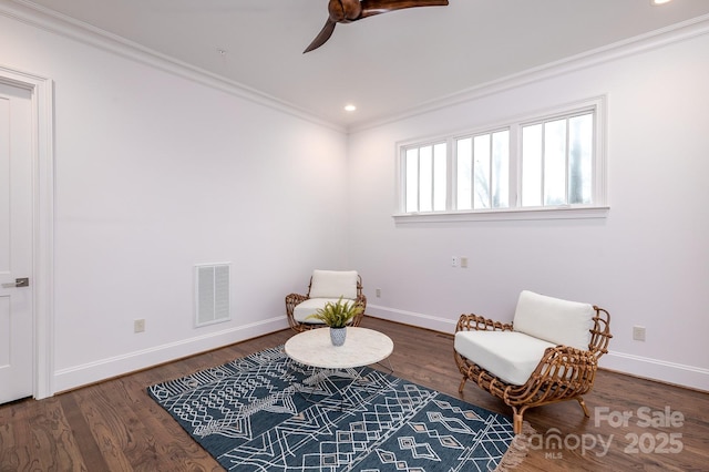 sitting room featuring ornamental molding, ceiling fan, and dark hardwood / wood-style flooring