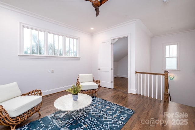 living area with dark hardwood / wood-style flooring and crown molding