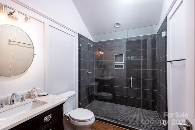 bathroom featuring vanity, an enclosed shower, lofted ceiling, and toilet