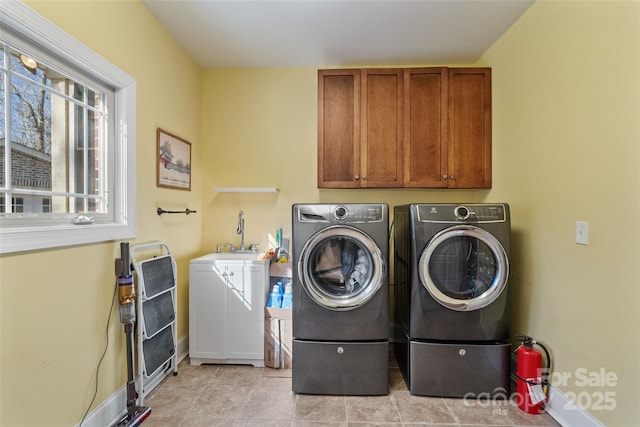 laundry room with cabinets, sink, and independent washer and dryer