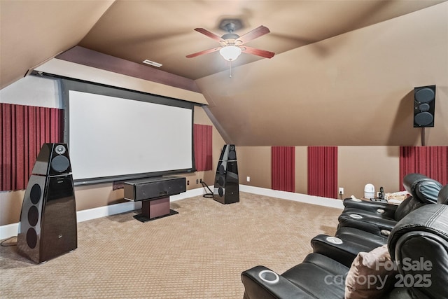 home theater room with lofted ceiling, light colored carpet, and ceiling fan