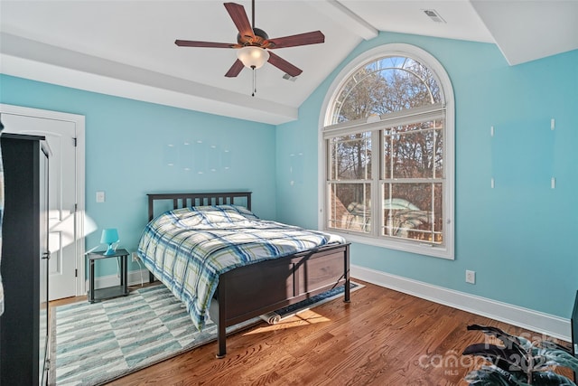 bedroom featuring hardwood / wood-style flooring, ceiling fan, and lofted ceiling with beams