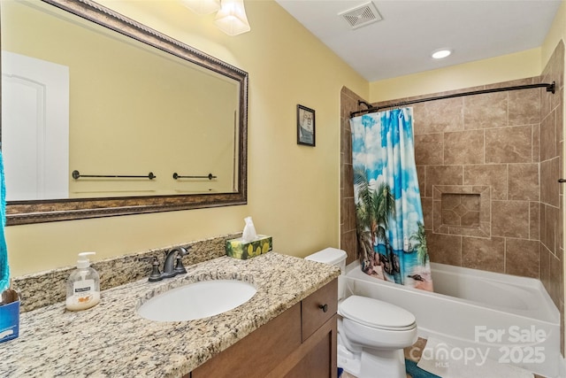 full bathroom with shower / tub combo with curtain, vanity, and toilet