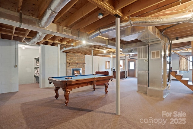 playroom with a brick fireplace and billiards