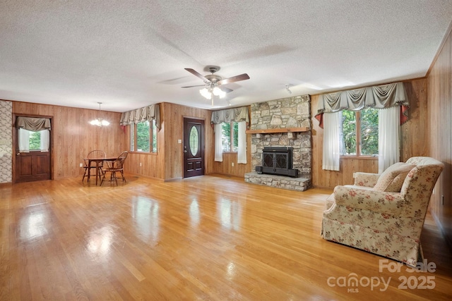 2076 Jay Clark Rd, Morganton, NC 28655 - living area featuring wood walls, a textured ceiling, ceiling fan with notable chandelier, and wood finished floors