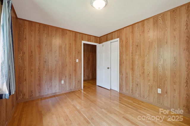 2076 Jay Clark Rd, Morganton, NC 28655 - spare room with baseboards, wooden walls, and wood finished floors