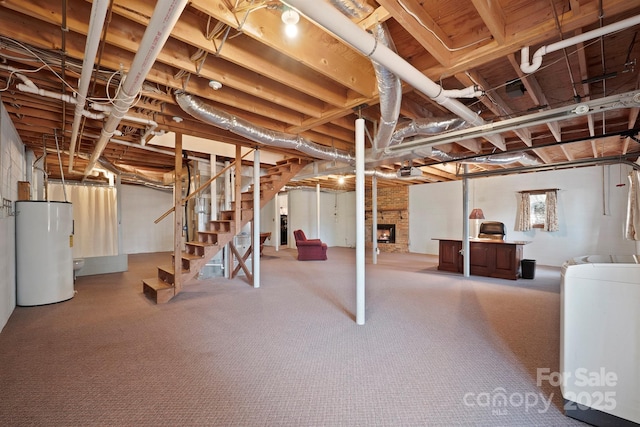 2076 Jay Clark Rd, Morganton, NC 28655 - below grade area featuring carpet, gas water heater, stairway, a large fireplace, and washer / clothes dryer