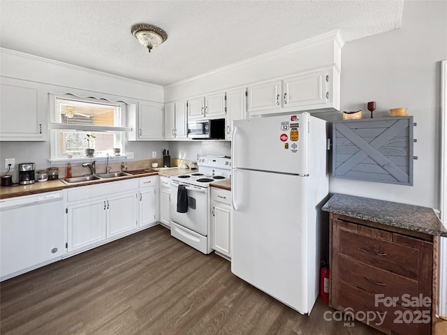 kitchen featuring white cabinetry, white appliances, dark hardwood / wood-style floors, and sink