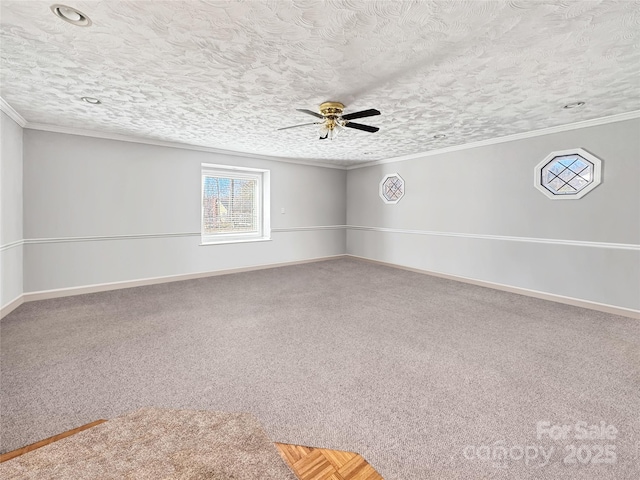 carpeted spare room with ceiling fan, crown molding, and a textured ceiling