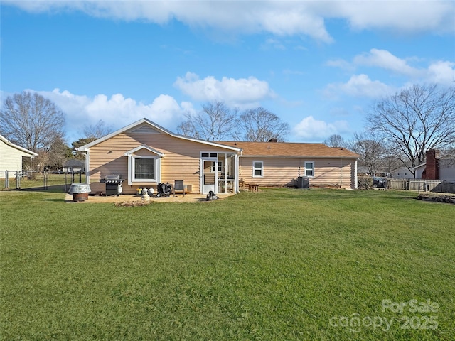 rear view of property with a patio and a lawn