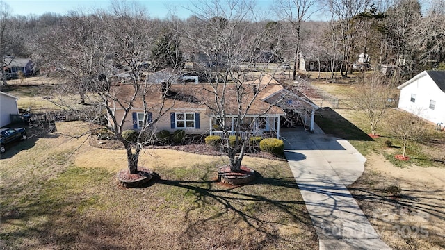 view of front of home with a front lawn and a carport