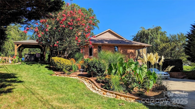 obstructed view of property with a gazebo and a front yard